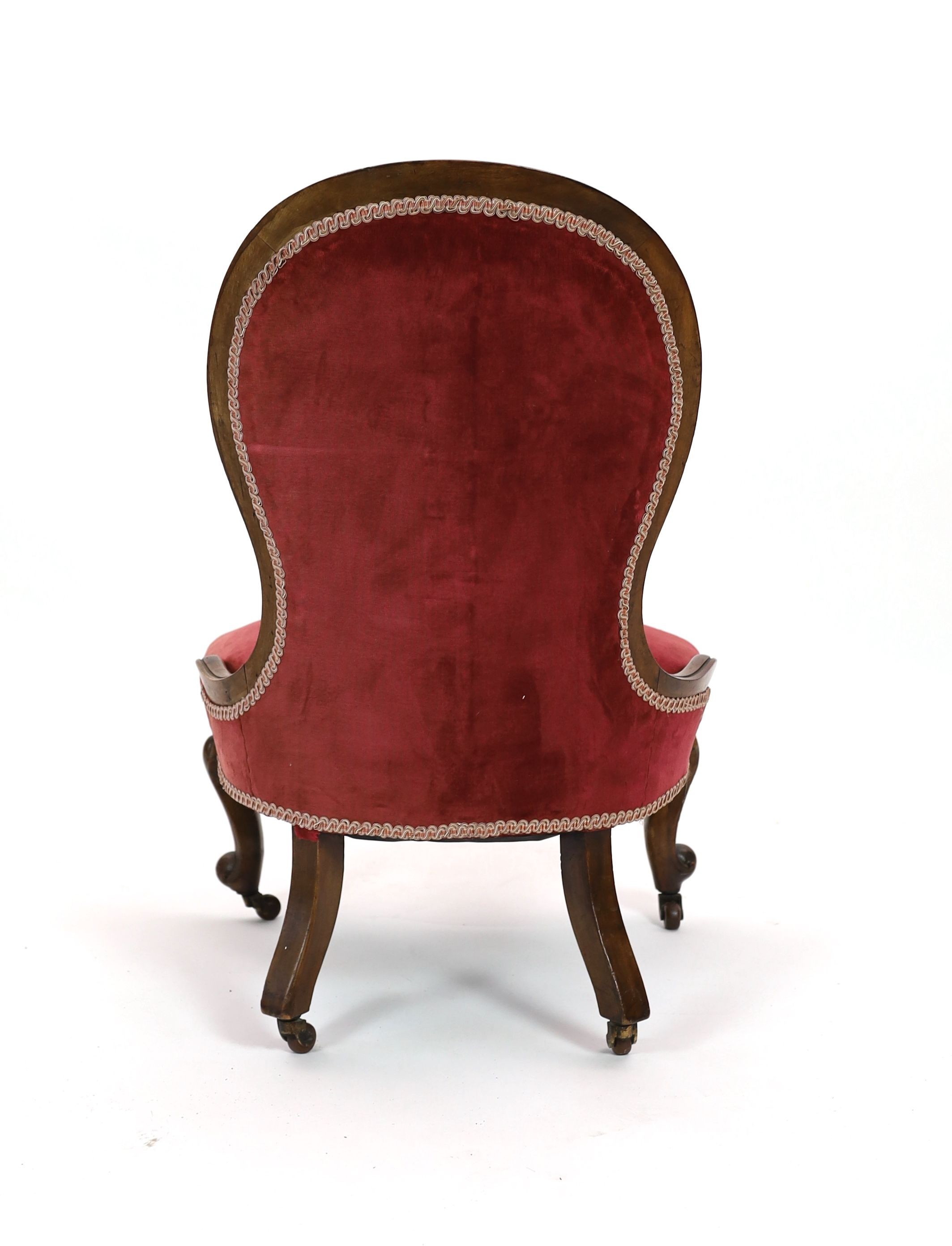 A Victorian walnut spoonback nursing chair, width 60cm depth 54cm height 92cm